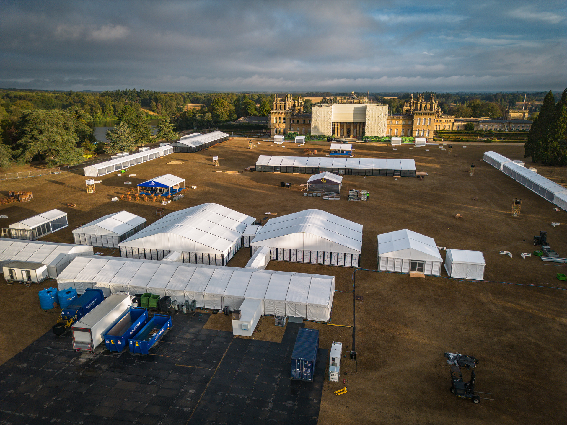 Aerial view of a marquee village under construction on a country estate